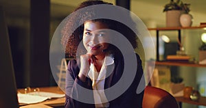 Smiling black female helpdesk worker having a conversation with a customer and doing overtime. Portrait of a young