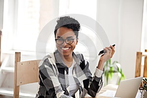 Smiling black girl laugh working at laptop in office