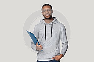 Smiling black male student stand holding binder case