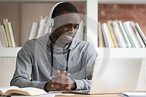 Smiling black male watch online training course at laptop