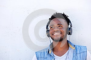 Smiling black man listening to music with headphones
