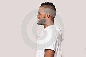 Smiling black man stand in profile isolated in studio