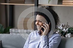Smiling black millennial female realtor talk on cell advice customer