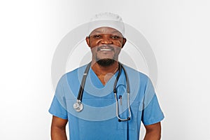 Smiling black surgeon doctor bearded man in blue coat, medical cap with stethoscope isolated white