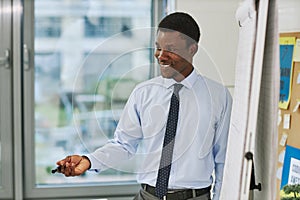 Smiling Black Teacher by Whiteboard