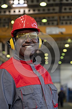 Smiling Black Worker In Personal Protective Equipment Looking At Camera