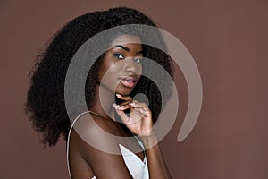 Smiling black young woman isolated on brown background. Beauty, skincare concept