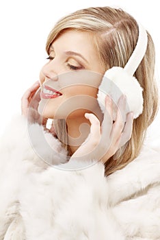 Smiling blond in furry headphones