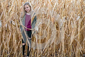 Smiling blond girl in cornfield