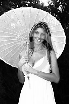 Smiling Blond lady holding umbrella