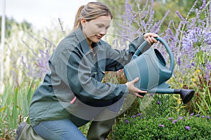 Smiling blond woman gardening