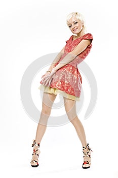 Smiling blond woman standing in short red dress