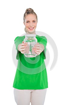 Smiling blonde activist holding glass jar