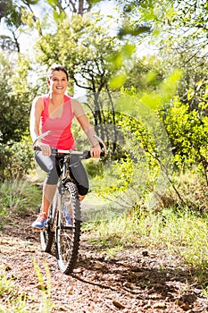 Smiling blonde athlete mountain biking