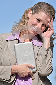 Smiling Blonde Business Woman Wearing Suit With Tablet