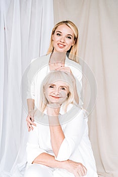 Smiling blonde grandmother and granddaughter together