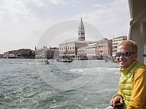 Smiling blonde man travels to Venice