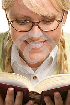 Smiling Blonde With Ponytails Reads a Book photo