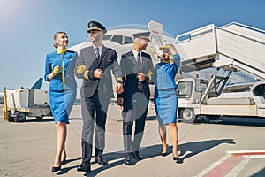 Smiling blonde stewardesses and airmen in sunglasses