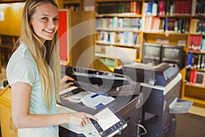 Smiling blonde student making a copy