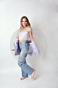 Smiling blonde woman with jeans trousers