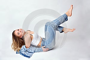 Smiling blonde woman lies on the floor