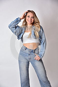 Smiling blonde woman wearing jeans jacket and trousers