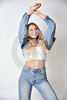 Smiling blonde woman wearing jeans jacket and trousers