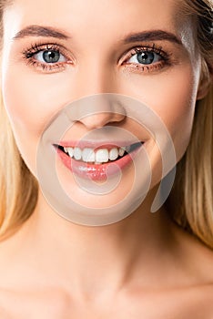 Smiling blonde woman with white teeth