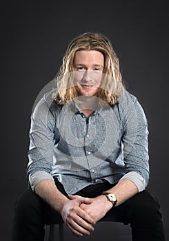 Smiling blonde young man with long hair and beard