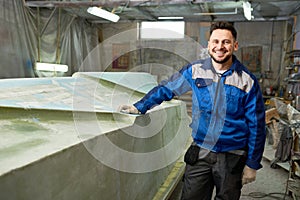 Smiling Boat Repairman Posing in Workshop