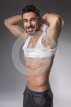 Smiling bodybuilder demonstrating great forms photo