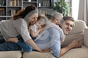 Smiling bonding family enjoying playtime together at home.