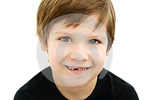 Smiling boy without a baby tooth on a white background