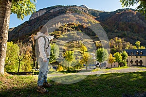 Smiling boy with backpack in autumn mountains
