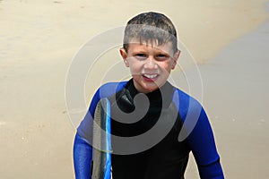 Smiling boy with bodyboard