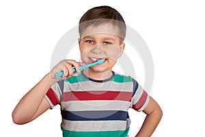 Smiling boy brushes his teeth, isolated on a white background