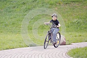 Smiling boy cycling in park