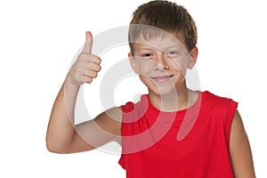 Smiling boy demonstrates thumb up