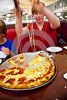 Smiling boy in a diners at night photo