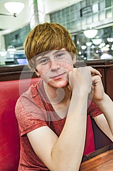 Smiling boy in a diners at night photo