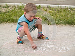 Smiling boy drawing