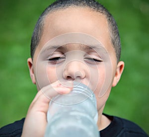 Smiling boy drinking