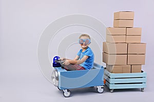 Smiling boy driving blue, fanny car.