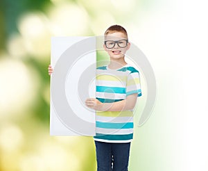 Smiling boy in eyeglasses with white blank board