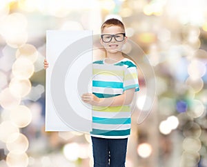 Smiling boy in eyeglasses with white blank board