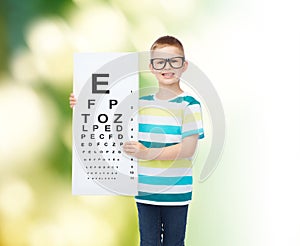 Smiling boy in eyeglasses with white blank board