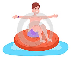 Smiling boy floating on swimming donut. Happy kid