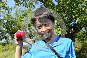 Smiling boy with fresh apple