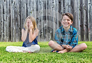 Smiling boy and girl on grass